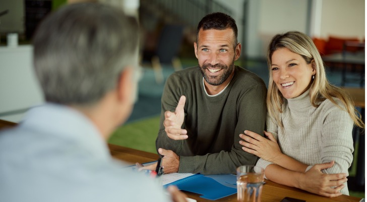 A married couple discusses universal life insurance with their financial advisor.