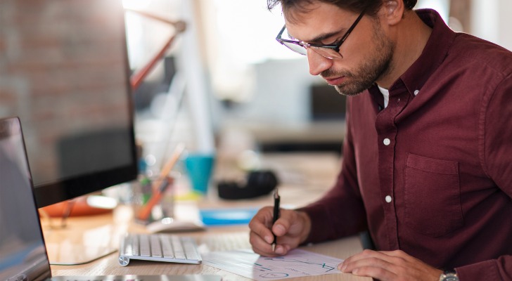 A man signing his online will.