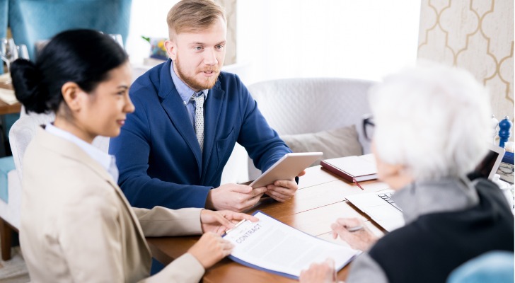 Elderly woman discussing an inheritance with financial advisors