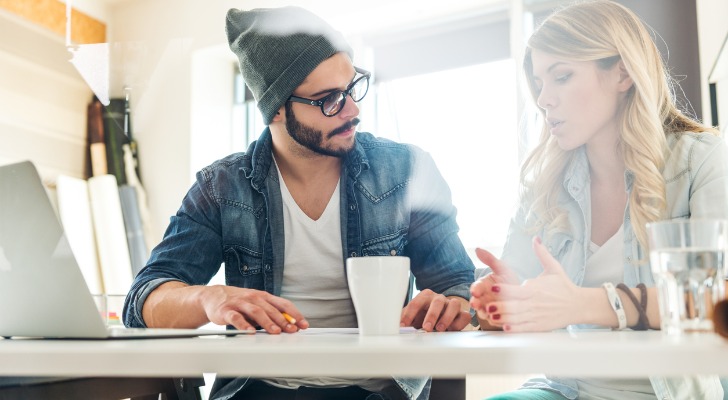 An advisor explaining the best retirement plans to a young adult