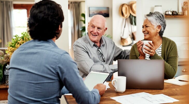 A couple sit down with their advisor to discuss ways to reduce taxes on your retirement accounts.