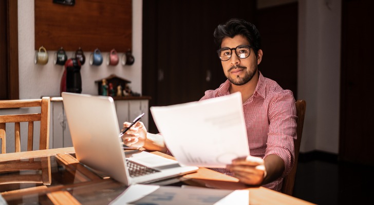 A man looking through his online will.