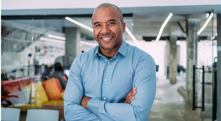 An angel investor stands inside the office of a company he invested in.