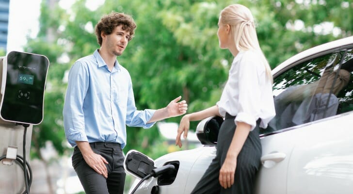 Two drivers discuss how to get a tax credit for leasing an electric vehicle.