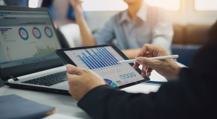 An investor looking at investments, preparing to calculate capital gains taxes owed.