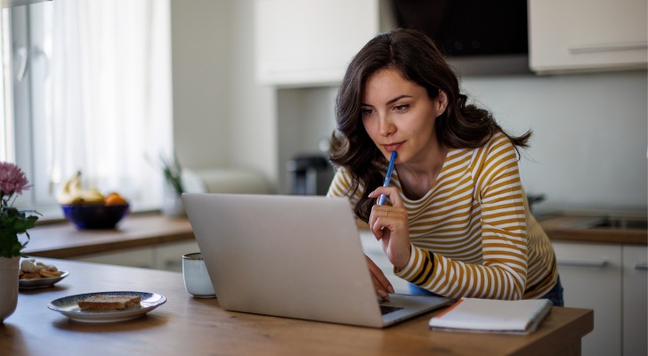 Young woman using a laptop while working from home.