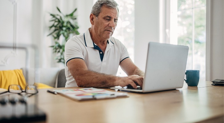 A man looking up the IRA rollover contribution limits.
