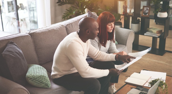 Couple looking at their investment expenses