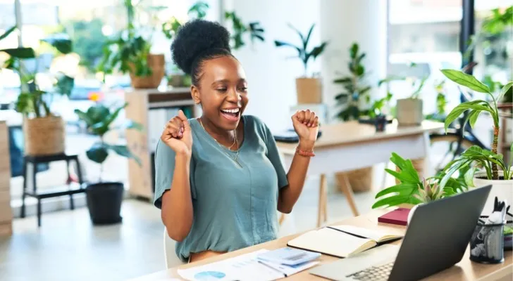 A woman reviewing how much she will make in dividends with her $100,000.