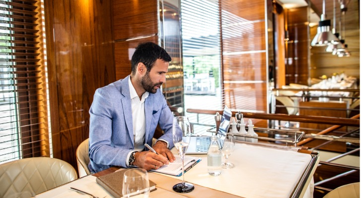 A wealthy business owner looks over financial reports.