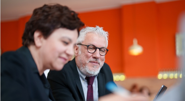 Two financial advisors review their firm's SEC registration.