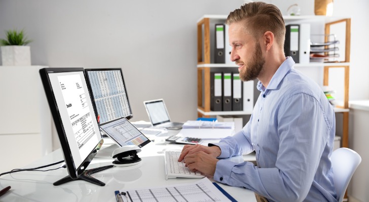 A RIA owner looking at a new software solution and taking notes.