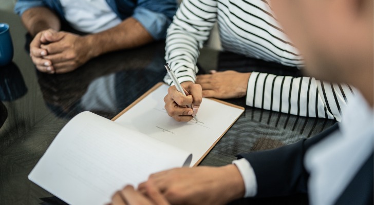 Woman signs legal documents regarding her inherited IRA