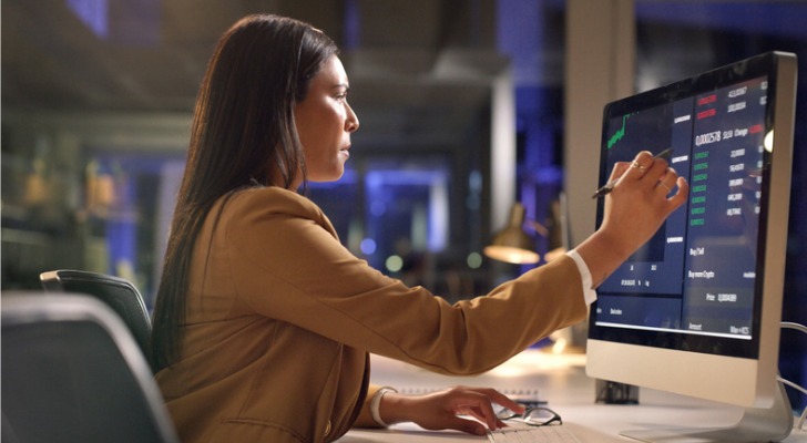 A woman looking at potential tax costs of her dividend reinvestments
