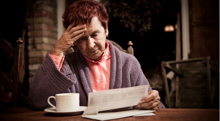 A woman stressed because her bills are too much for her low income retirement