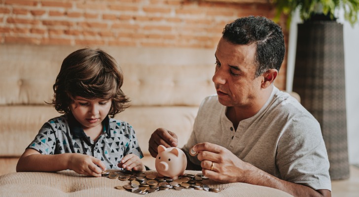 A man teaching his son about gold IRA investing and saving for retirement in a 401(k).