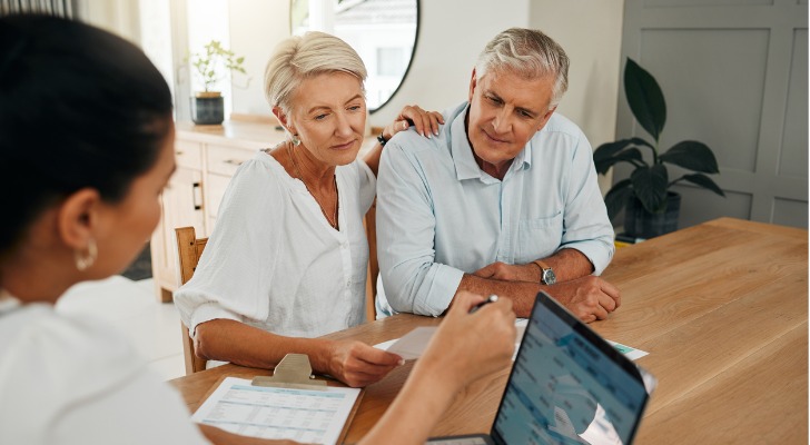 A financial advisor meets with a married couple to discuss their financial plan and investments.
