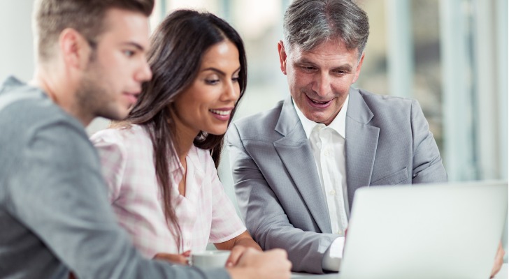 An investment advisor reviewing a portfolio with clients.
