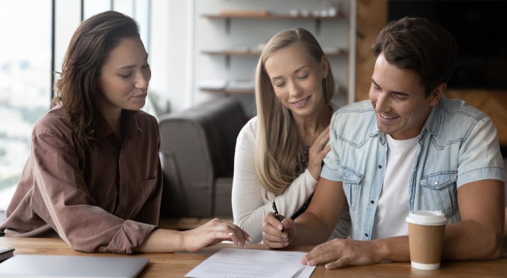 A couple in their 20s working with a financial advisor