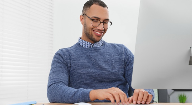 A man working on his Ph.D. thesis in financial planning