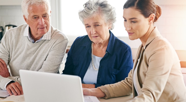A senior couple meeting with an advisor to review their annuity.
