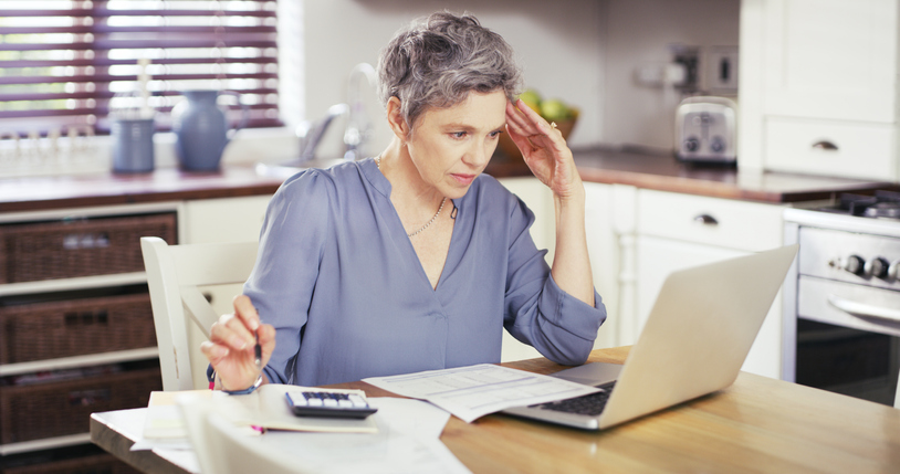 Woman contemplates how much money to leave in her checking account.