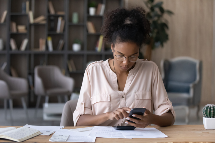 A woman evaluating the cost of hiring a financial advisor