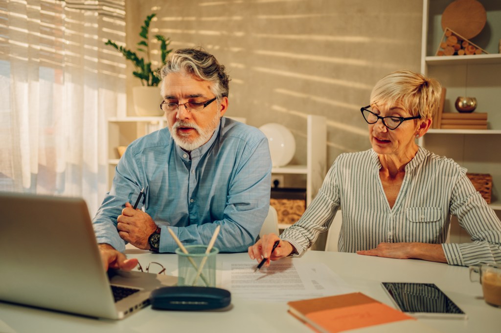 A couple calculates the cost of mortgage insurance