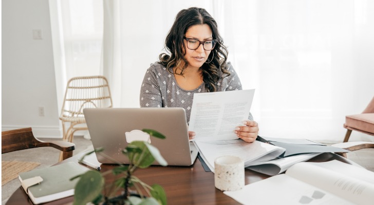 A woman prepares her tax return by adding up her various streams of income.