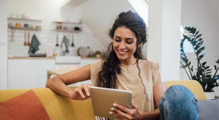 A woman looking to open an online savings account and looking at the minimum balance requirement.