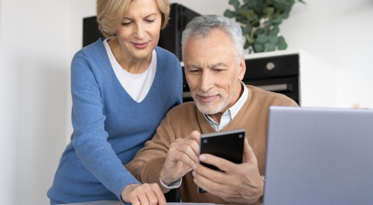 A senior couple calculating a buyout option.