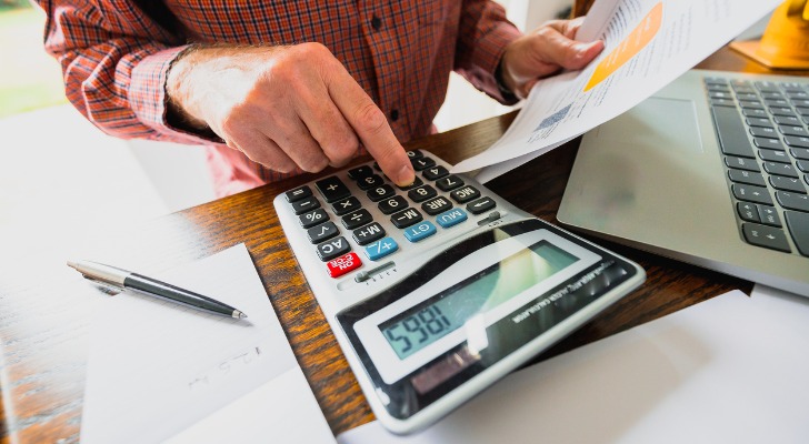 man calculating how much a 401k loan would cost