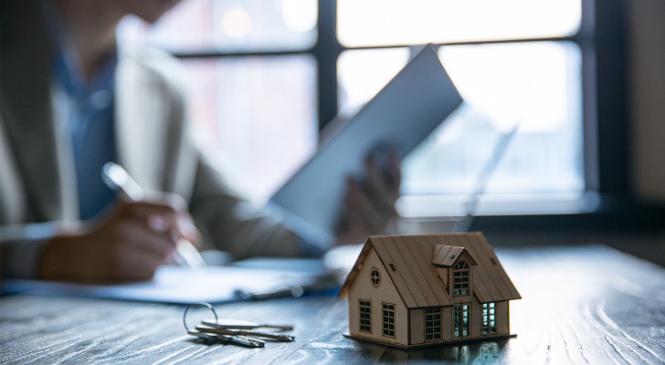 A home buyer signs mortgage documents.
