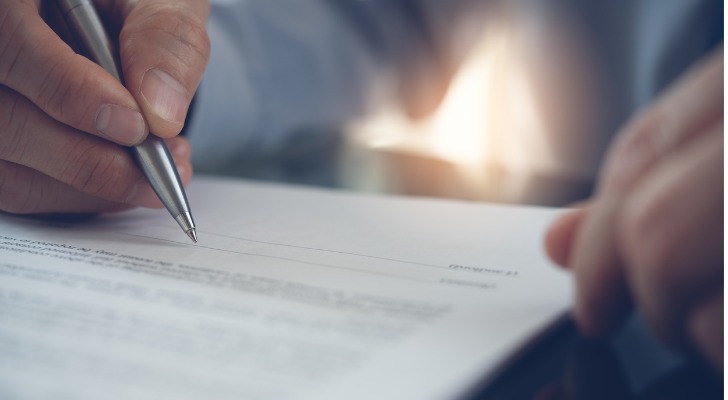 A homeowner signs a mortgage forbearance agreement.