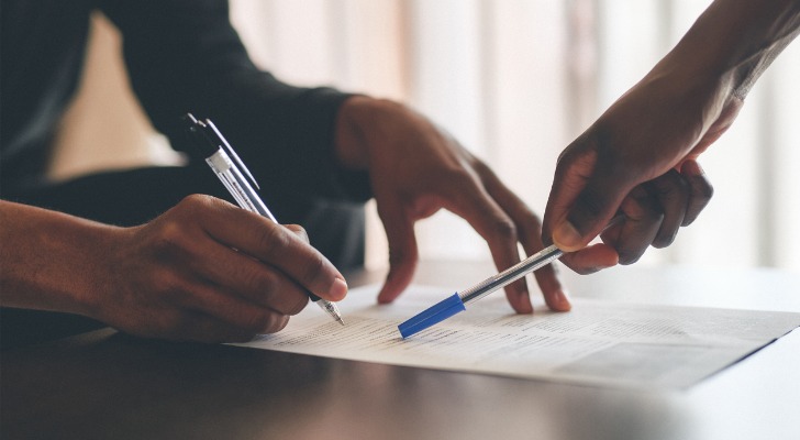 A couple reviews a life insurance loan document.