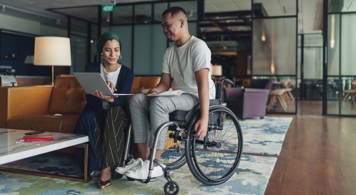 Man in wheelchair consulting with his financial advisor
