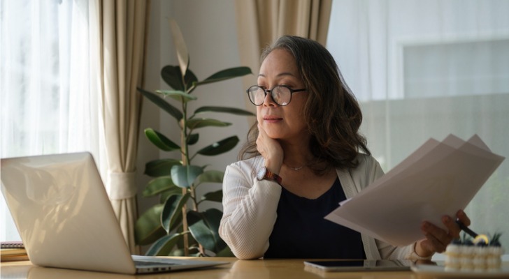 Woman looking at the list of taxes she is paying in retirement.