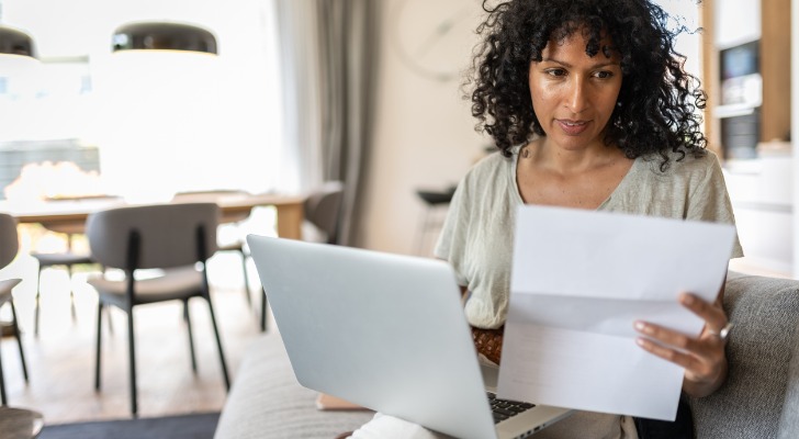 A woman calculating her penalties for cashing out her 401(k)