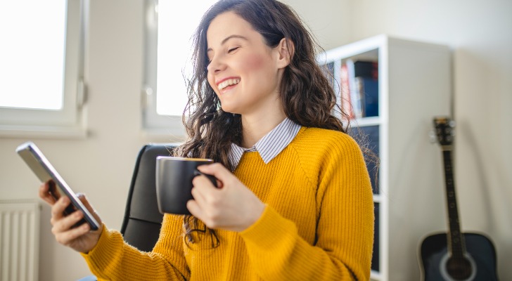 A woman reading a financial advisor magazine online
