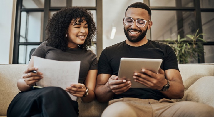 A couple reviewing the benefits and drawbacks of a CD loan.