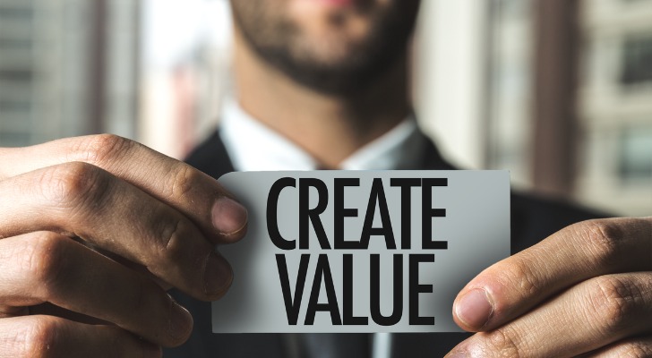 A financial advisor holding a sign about creating value to help with his value proposition