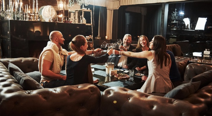 Siblings and their spouses toast after reviewing their family estate plan.