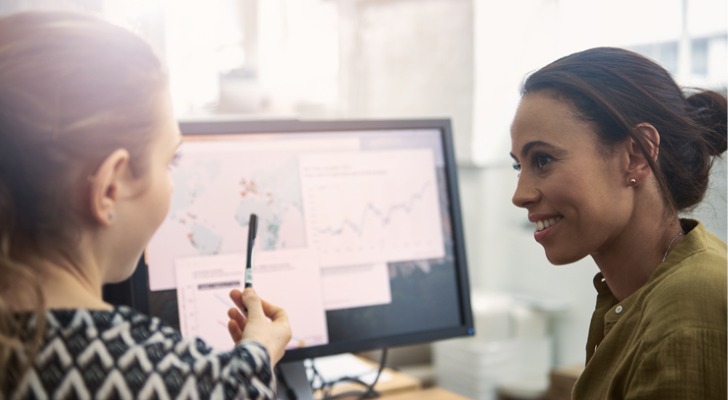 Two financial advisors analyze a client's portfolio.