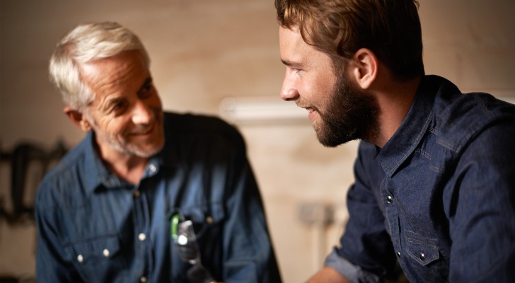 A man explaining the succession plan for his family business to his son.