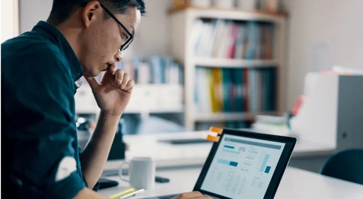 A man looks over his investment portfolio, which is just one component of his comprehensive financial plan.