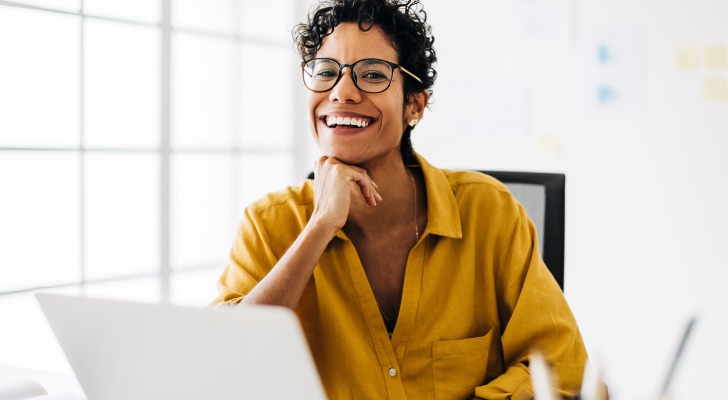 A financial advisor smiles while siting in her office.