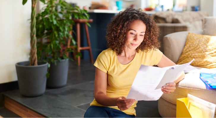 A woman analyzing differences between ETFs, mutual funds and index funds.