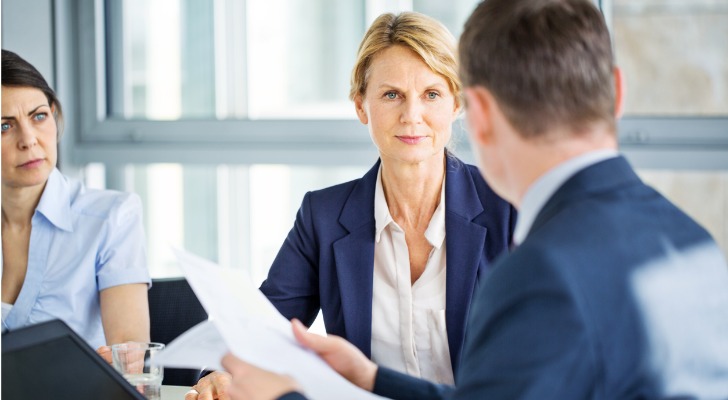 A woman listens during a board of directors meeting for her family's private foundation.