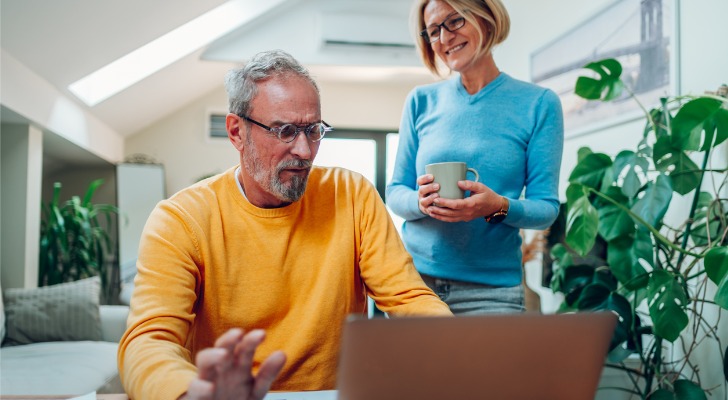 A couple doing their taxes and trying to calculate the impact of their 401(k) to IRA rollover