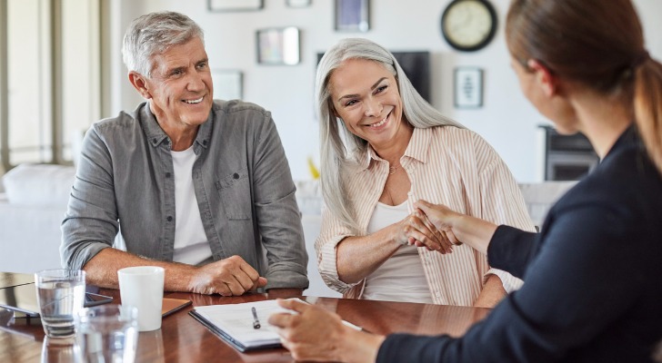 A couple talking to a financial advisor about bonus annuities.